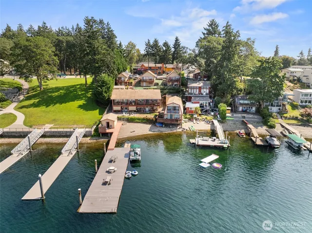 an aerial view of a swimming pool with outdoor seating