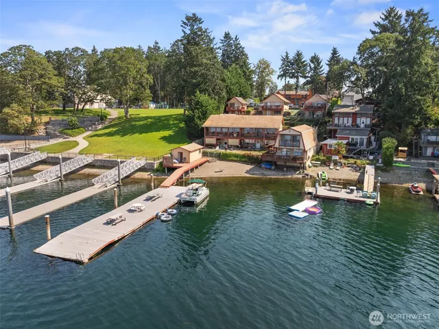 an aerial view of a house with a garden and lake view