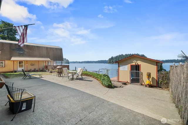 a view of a terrace with chairs and a small yard