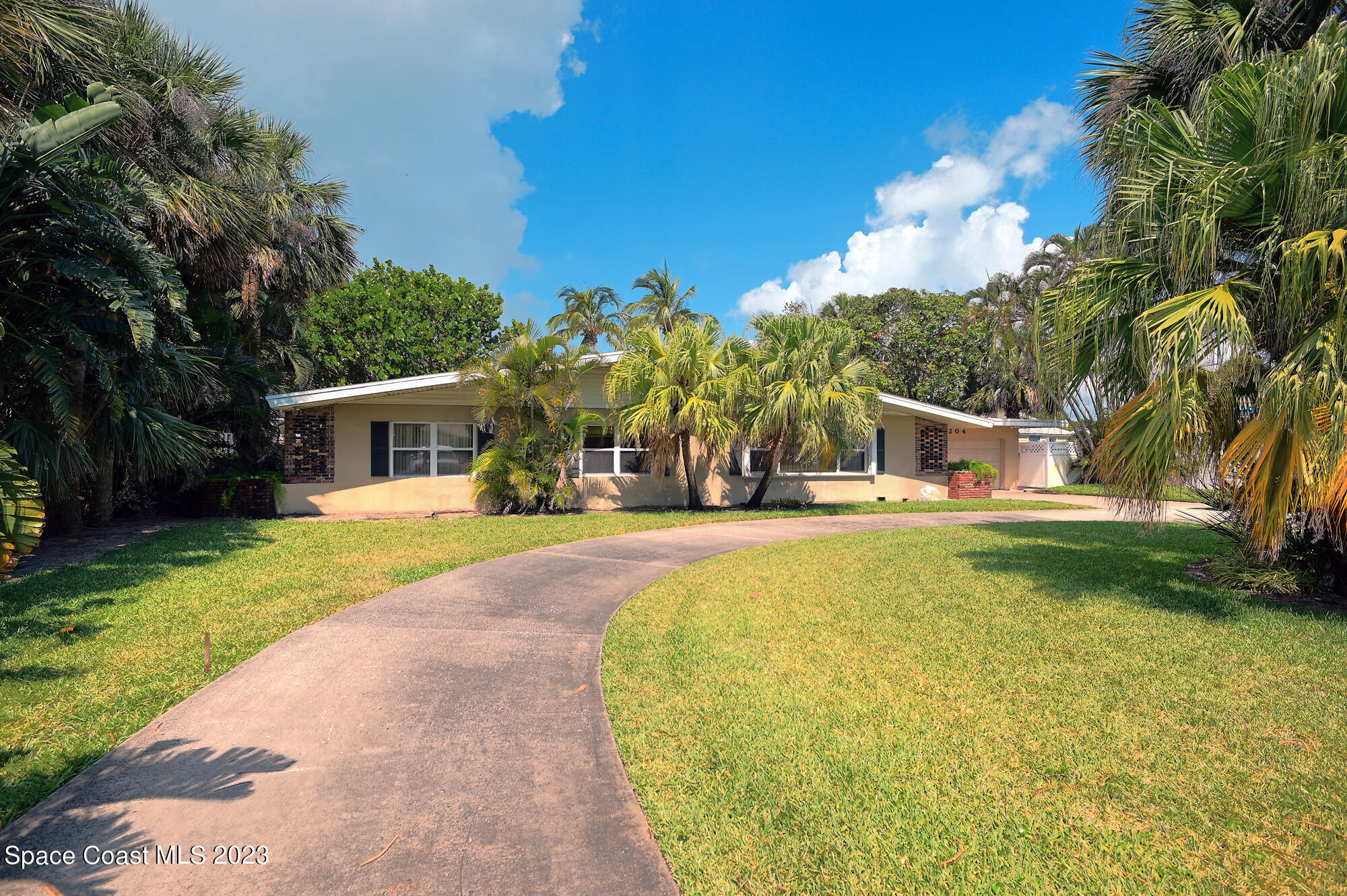 a view of house with outdoor space and swimming pool