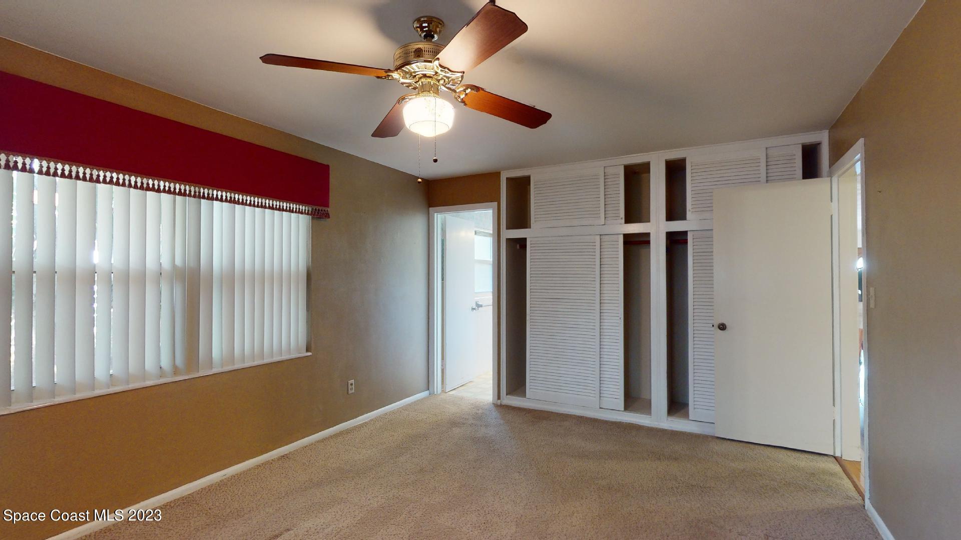 204 South Riverside Drive Indialantic, FL 32903 - Photo 14 of 24 an empty room with closet and windows