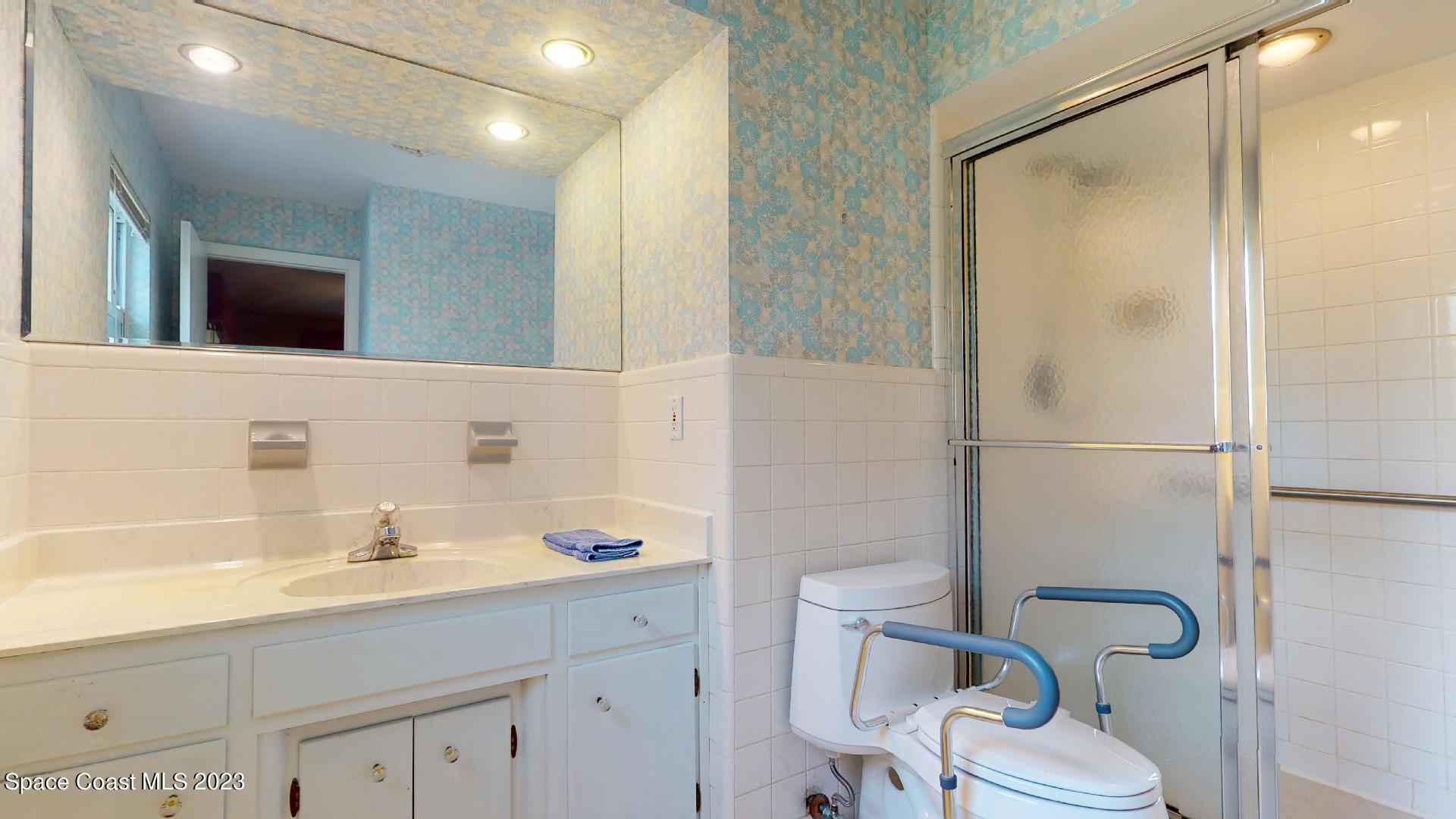 204 South Riverside Drive Indialantic, FL 32903 - Photo 15 of 24 a bathroom with a sink and a mirror