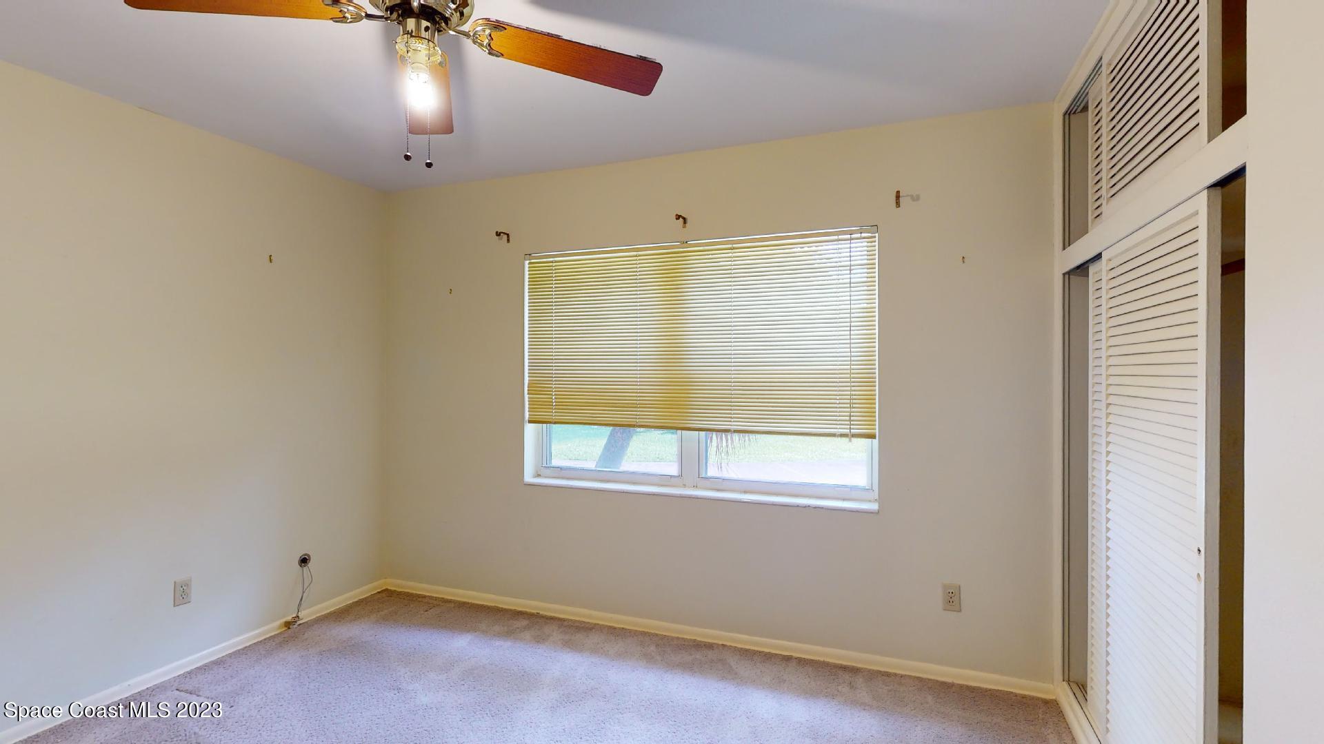 204 South Riverside Drive Indialantic, FL 32903 - Photo 16 of 24 an empty room with a window and ceiling fan