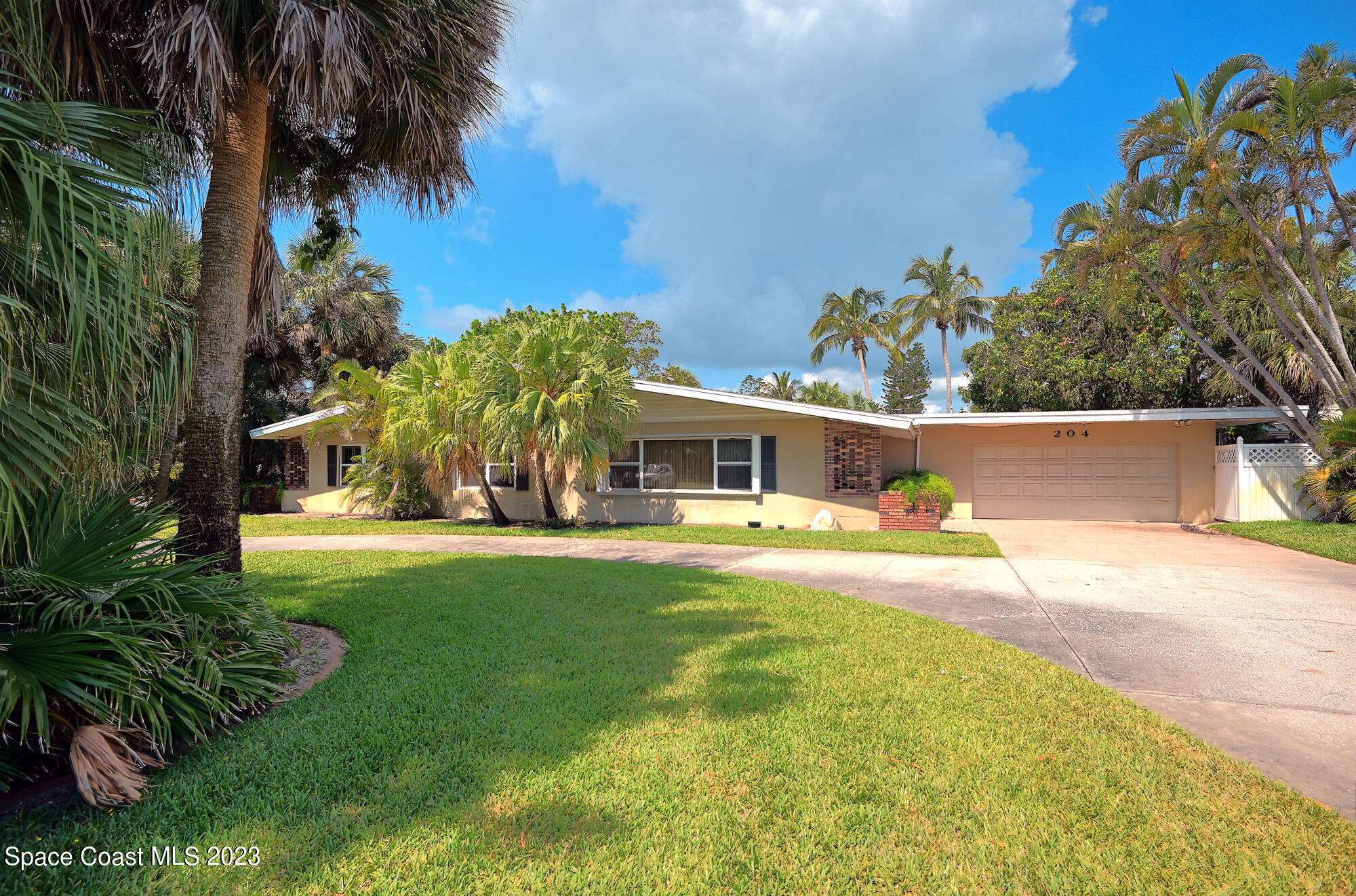 204 South Riverside Drive Indialantic, FL 32903 - Photo 2 of 24 a front view of a house with garden