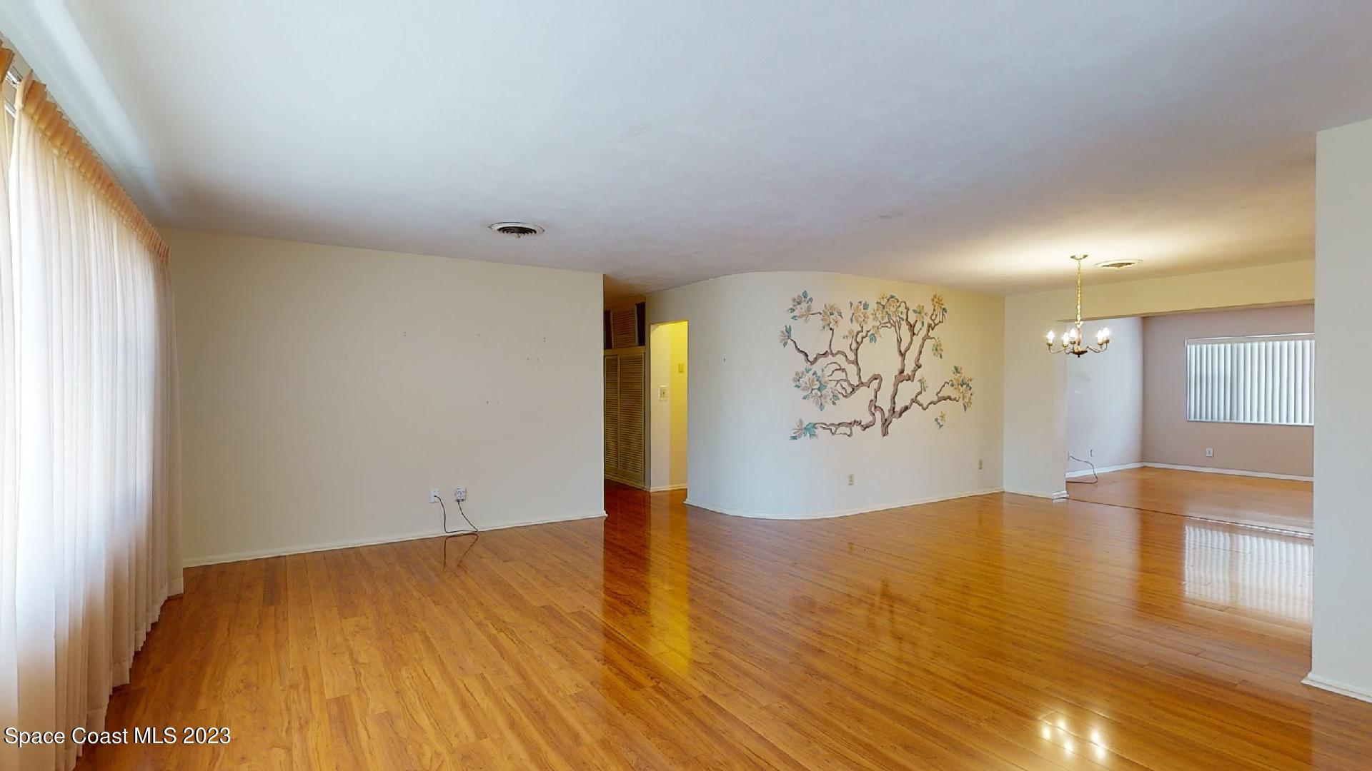 204 South Riverside Drive Indialantic, FL 32903 - Photo 5 of 24 a view of empty room with wooden floor