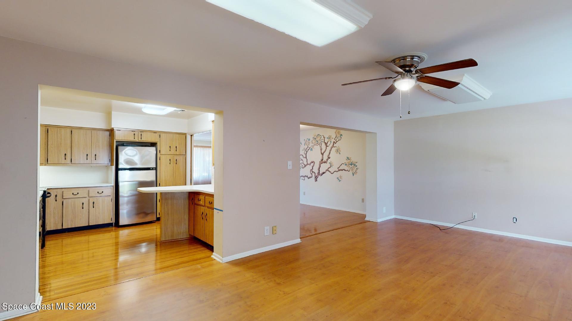 204 South Riverside Drive Indialantic, FL 32903 - Photo 10 of 24 a view of a kitchen with furniture and a ceiling fan