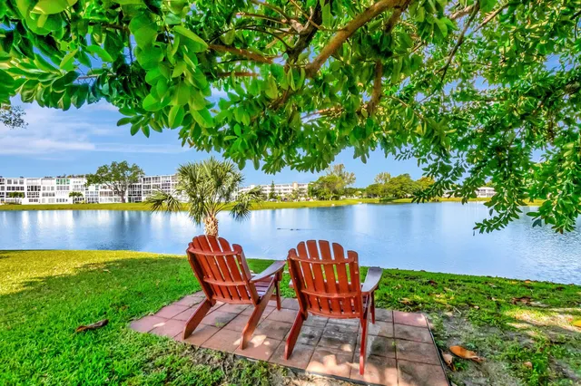 a living room with furniture and a dining table with kitchen view