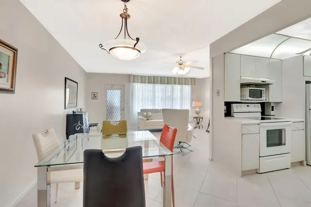 a view of a dining room with furniture a chandelier and wooden floor