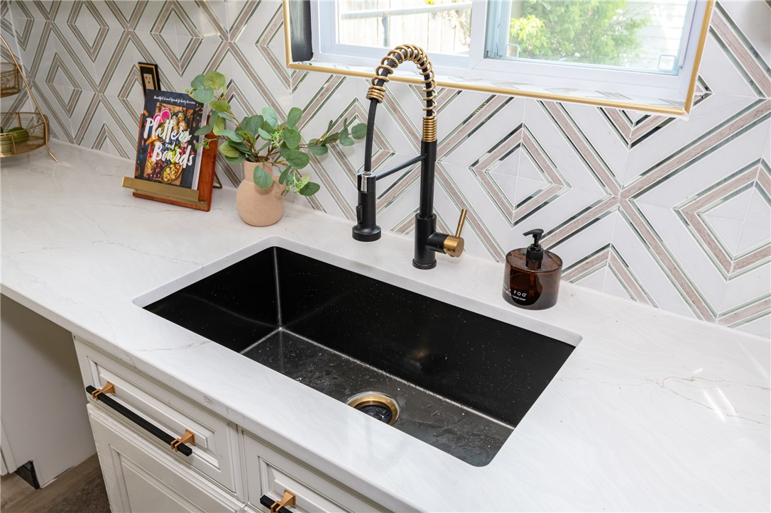 5240 Haverfield Road Dayton, OH 45432 - Photo 45 of 58 This modern kitchen features a sleek black sink with a stylish faucet, complemented by chic countertop.