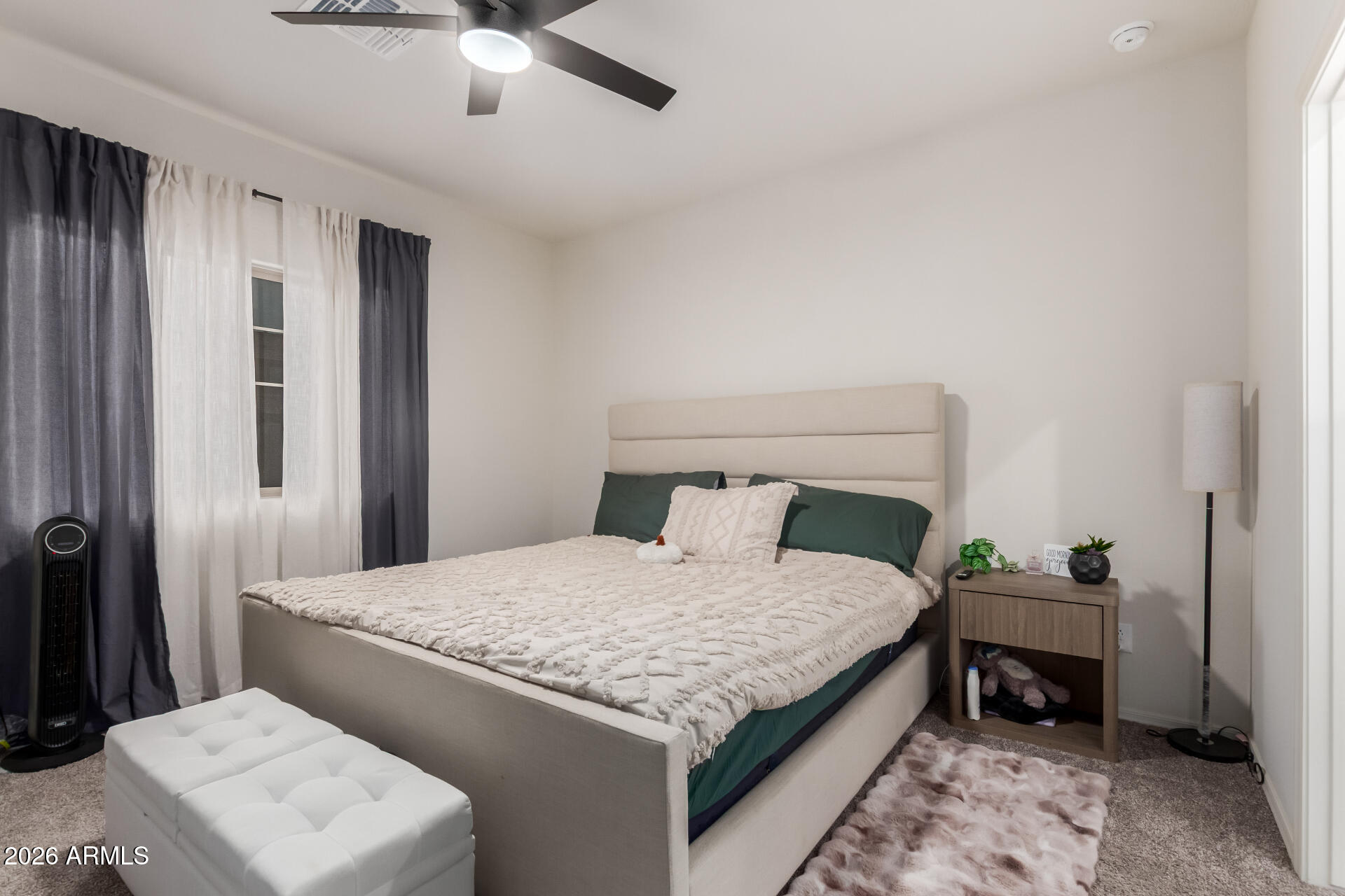 11214 West Bloch Road Tolleson, AZ 85353 - Photo 13 of 24 a bedroom with a bed and a chandelier