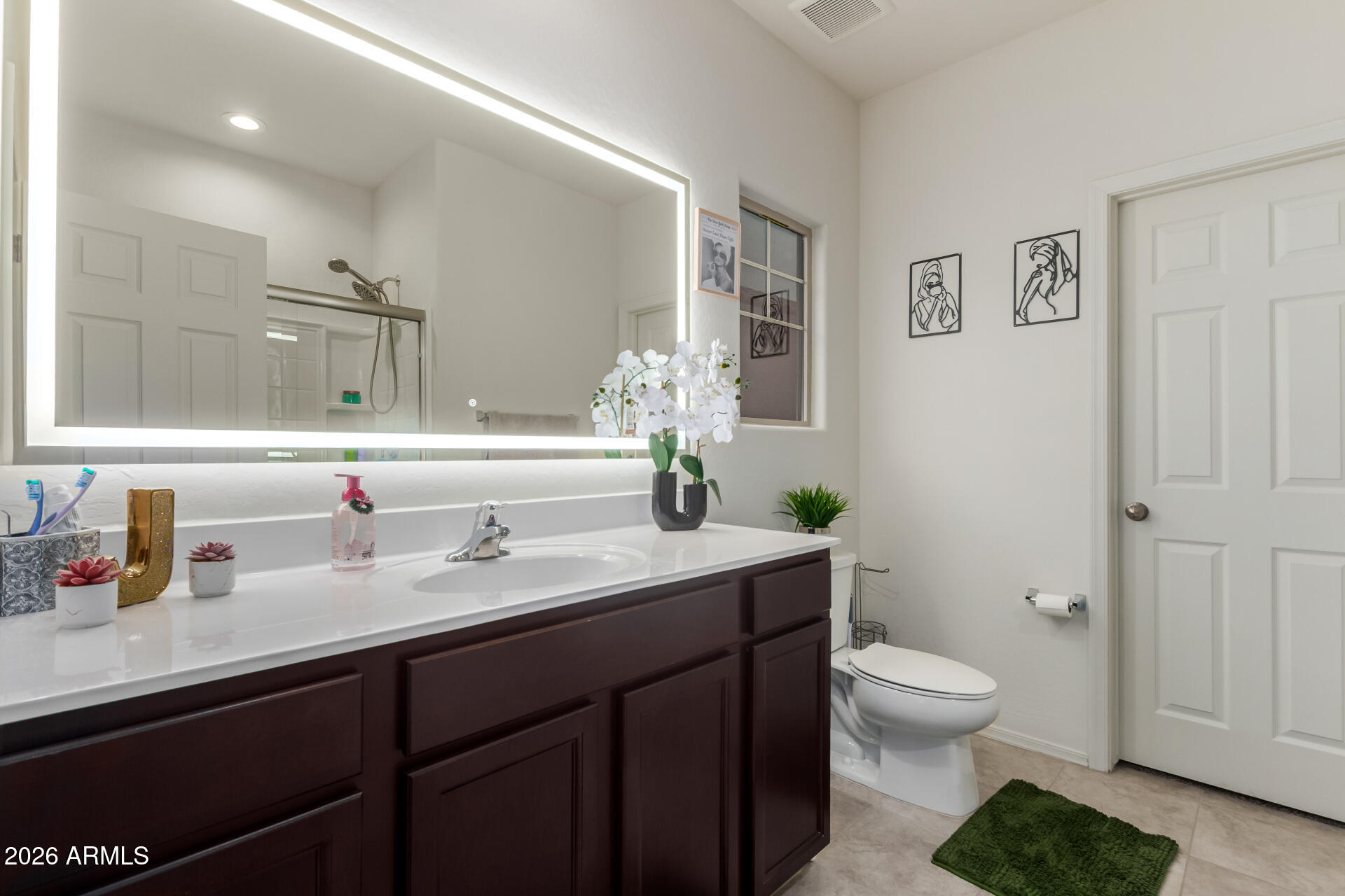 11214 West Bloch Road Tolleson, AZ 85353 - Photo 15 of 24 a bathroom with a granite countertop toilet sink and mirror