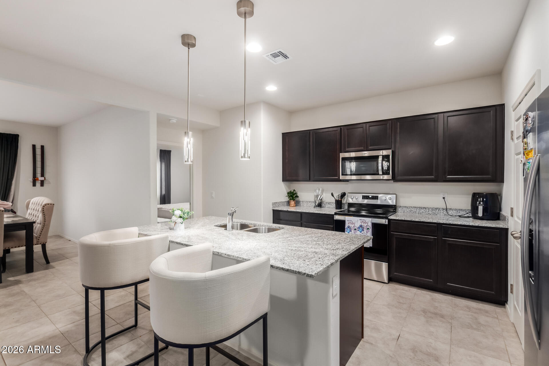 11214 West Bloch Road Tolleson, AZ 85353 - Photo 5 of 24 a kitchen with a sink a counter space appliances and cabinets