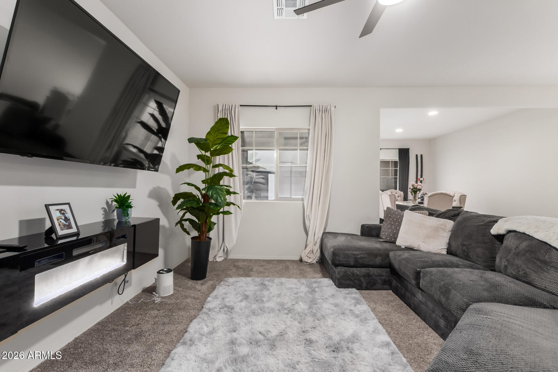 11214 West Bloch Road Tolleson, AZ 85353 - Photo 9 of 24 a living room with furniture potted plant and a window