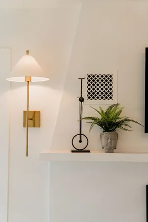 a table with a vase and a chandelier