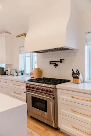 a kitchen with a stove and cabinets