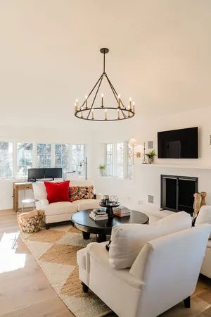 a living room with furniture a flat screen tv and a fireplace