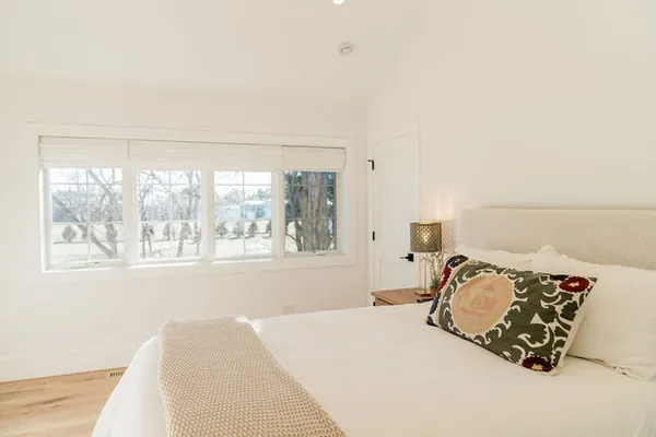 a bedroom with a bed and a window