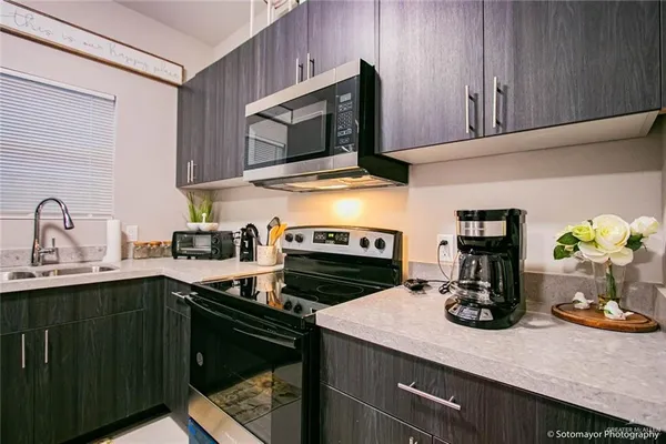 a kitchen with a sink stove and microwave