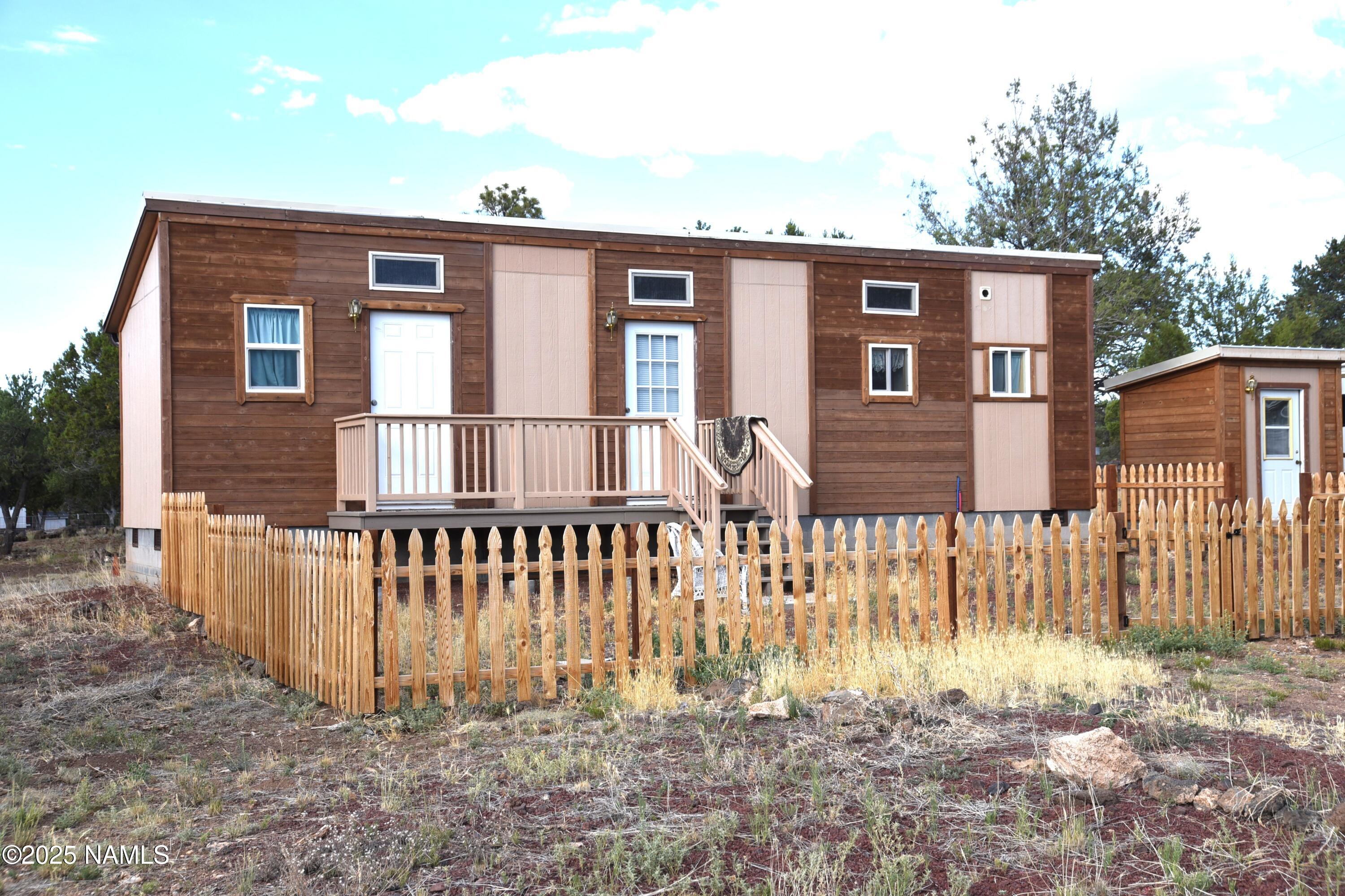 a front view of a house with a fence