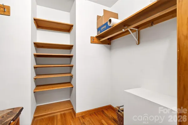 a view of walk in closet with empty racks