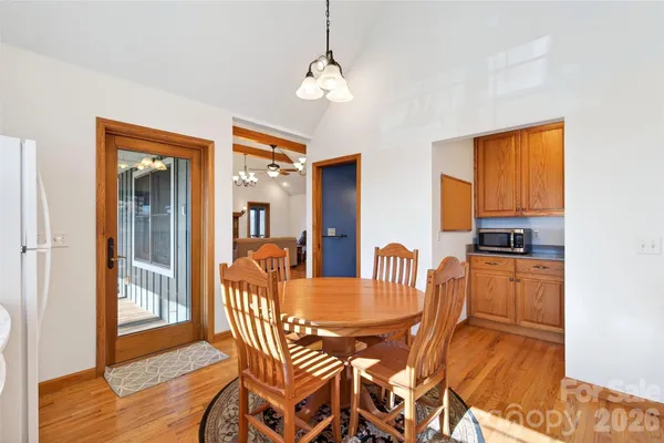 a dining room with furniture and wooden floor