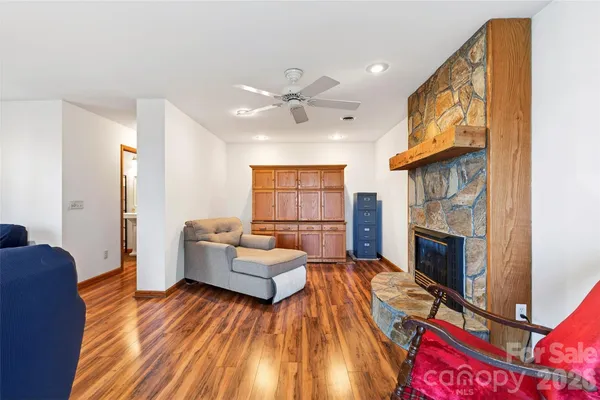 a living room with furniture fireplace and flat screen tv