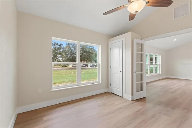 wooden floor in an empty room with a window