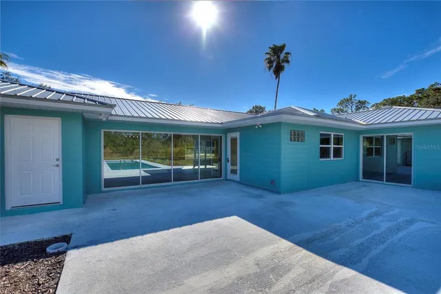 a view of a house with a backyard and plants