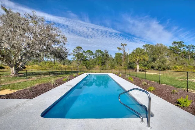 a view of a swimming pool with a yard