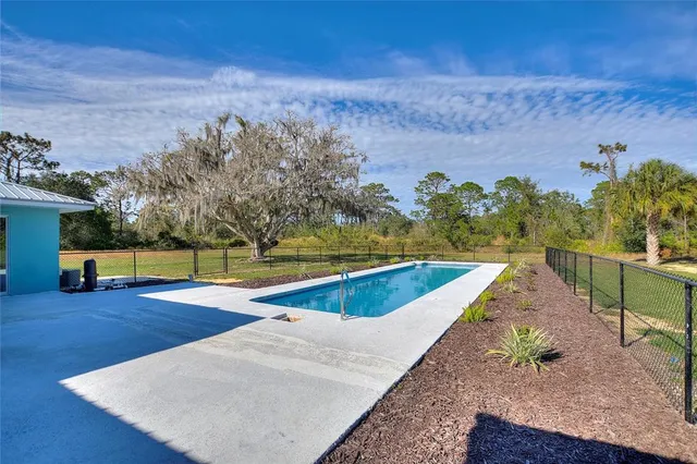 a view of a swimming pool with an outdoor space and seating area
