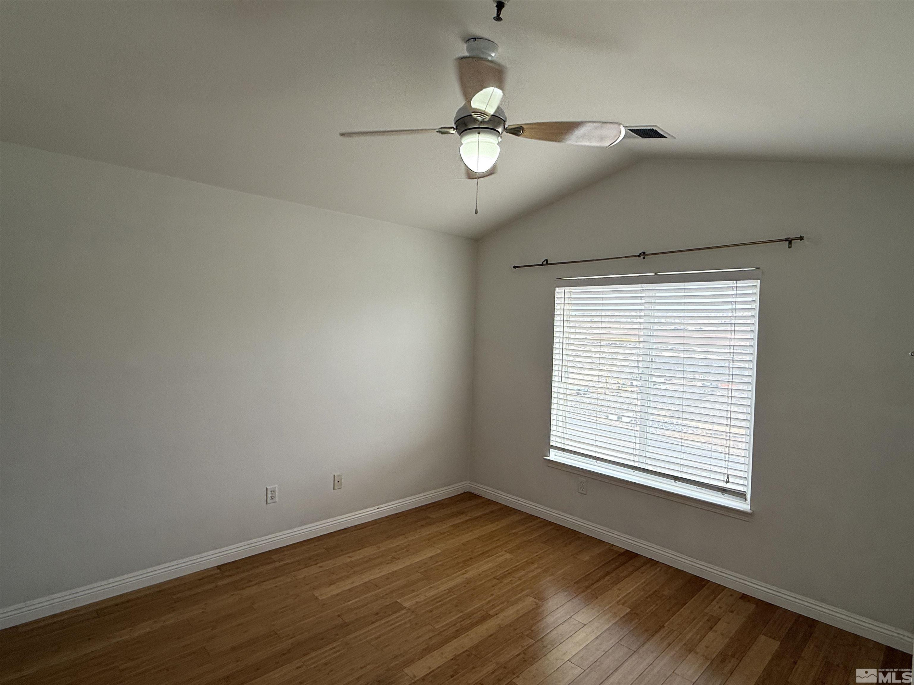 200 Talus Way, Unit 232 Reno, NV 89503 - Photo 16 of 29 an empty room with wooden floor chandelier fan and windows