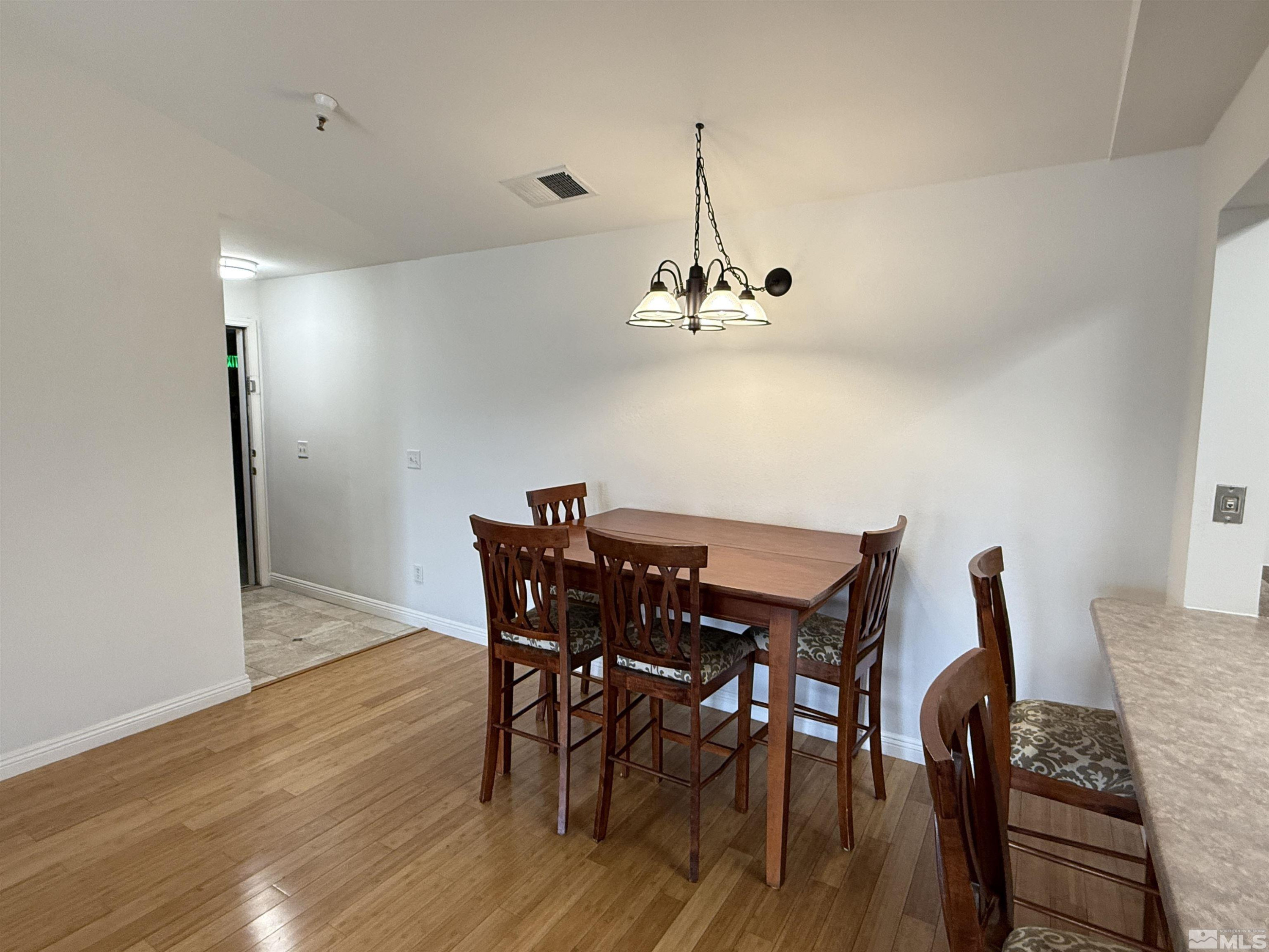 200 Talus Way, Unit 232 Reno, NV 89503 - Photo 4 of 29 a view of a dining room with furniture and wooden floor