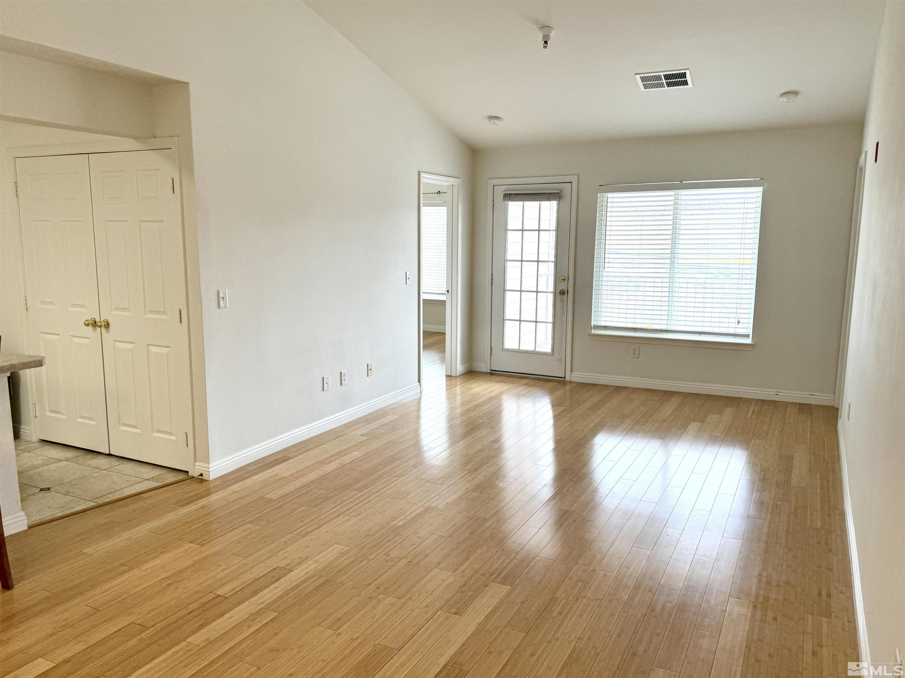 200 Talus Way, Unit 232 Reno, NV 89503 - Photo 5 of 29 an empty room with wooden floor and windows