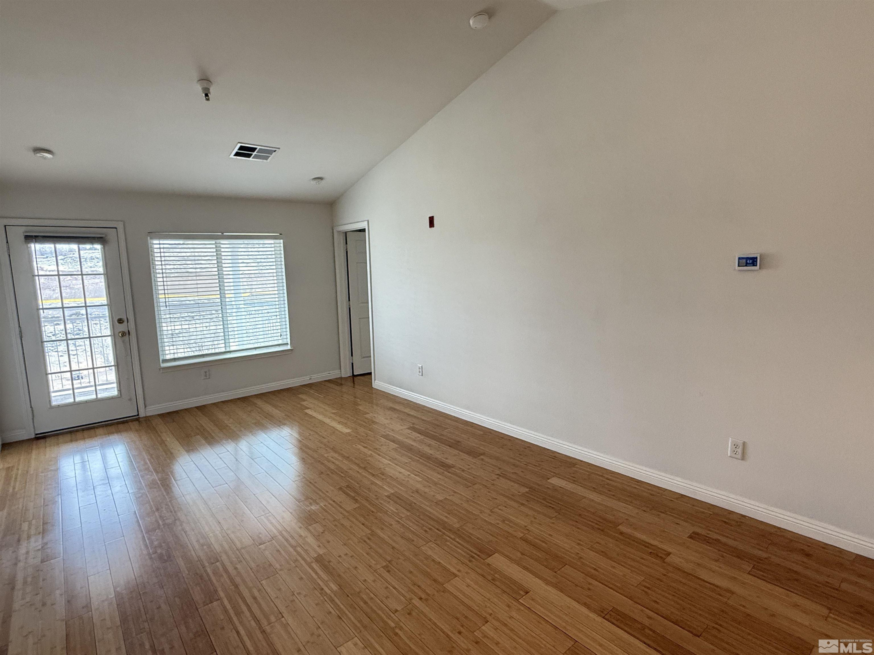 200 Talus Way, Unit 232 Reno, NV 89503 - Photo 6 of 29 a view of an empty room with wooden floor and window
