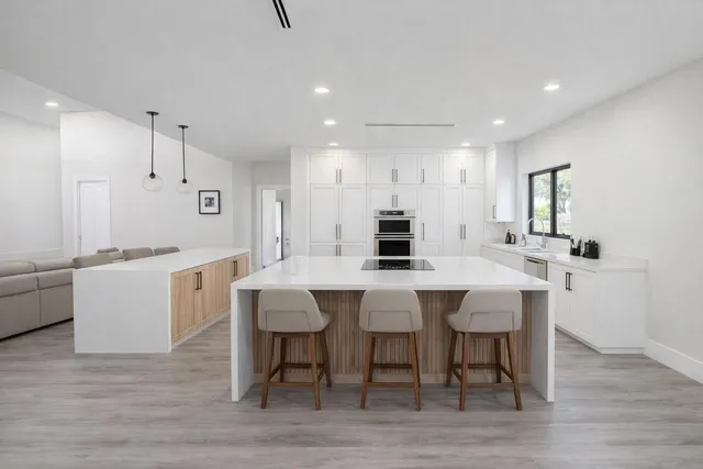 a large kitchen with a table and chairs