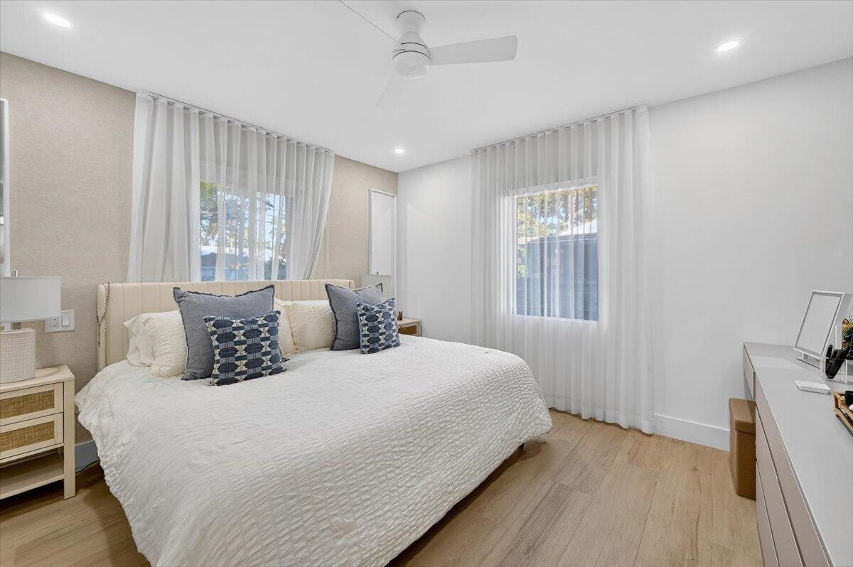 2601 Southwest 26th Lane Miami, FL 33133 - Photo 15 of 34 a bedroom with a large bed and wooden floor