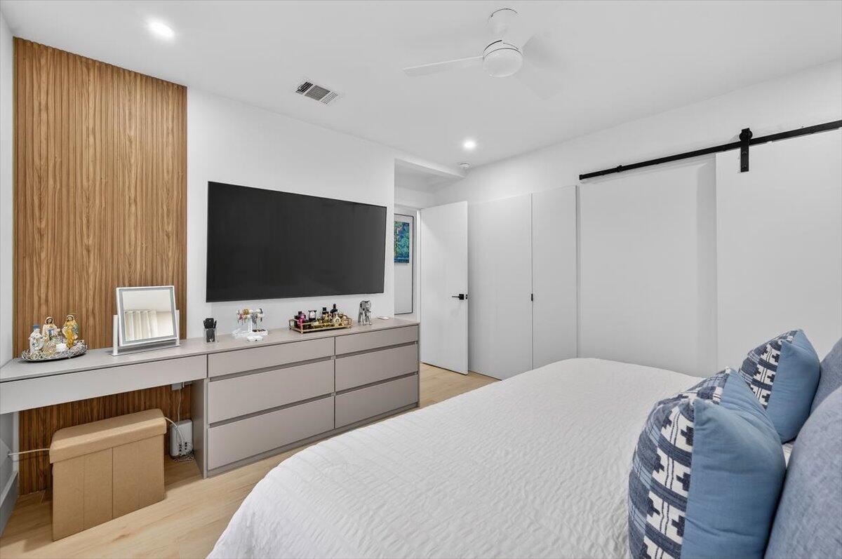 2601 Southwest 26th Lane Miami, FL 33133 - Photo 17 of 34 a bedroom with a bed and a flat screen tv