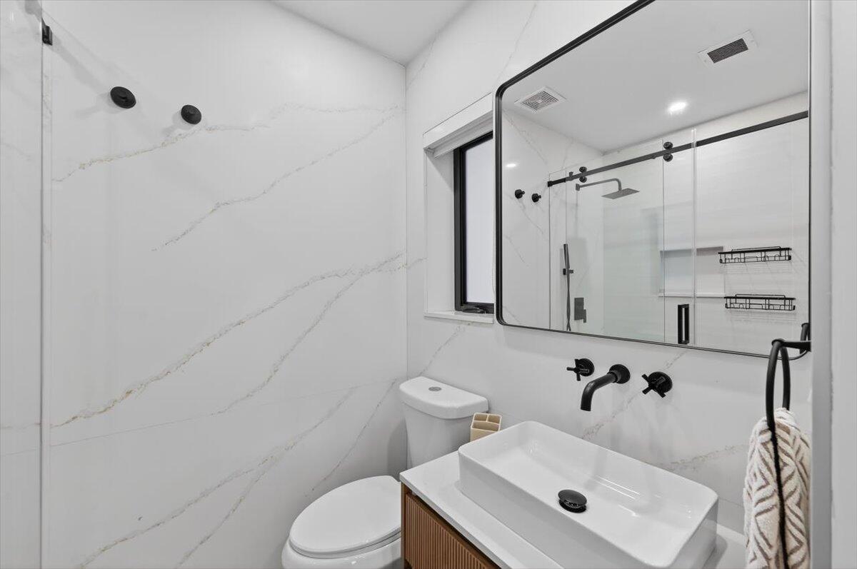 2601 Southwest 26th Lane Miami, FL 33133 - Photo 19 of 34 a bathroom with a sink toilet and shower