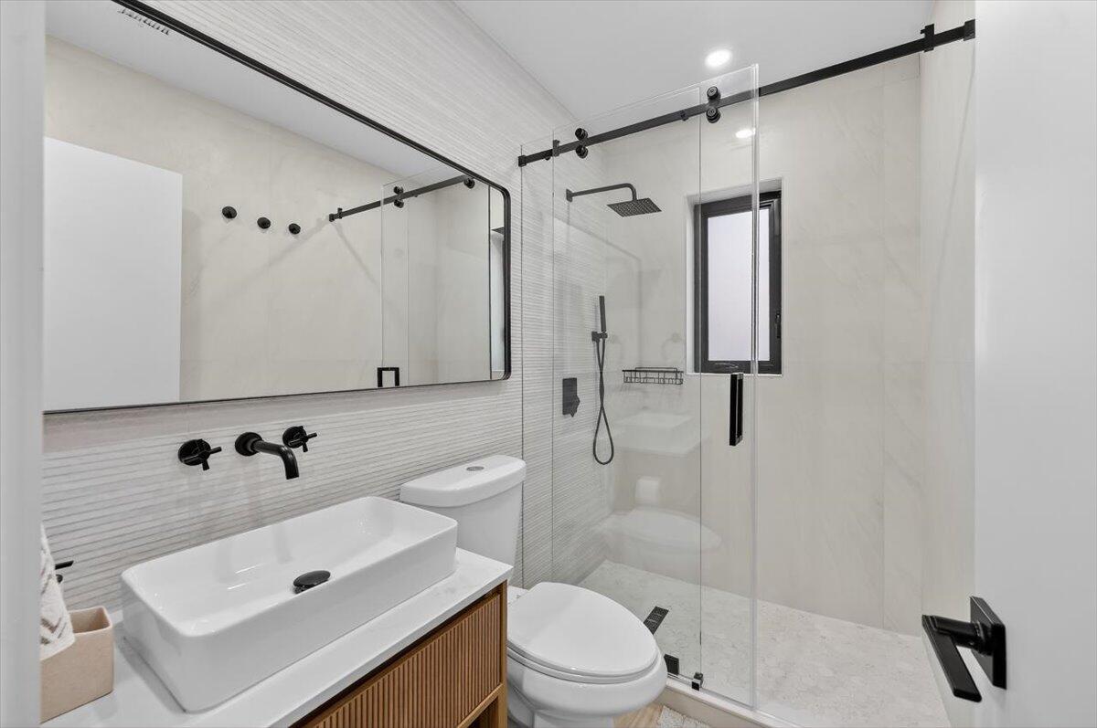 2601 Southwest 26th Lane Miami, FL 33133 - Photo 24 of 34 a bathroom with a sink toilet a shower and a mirror