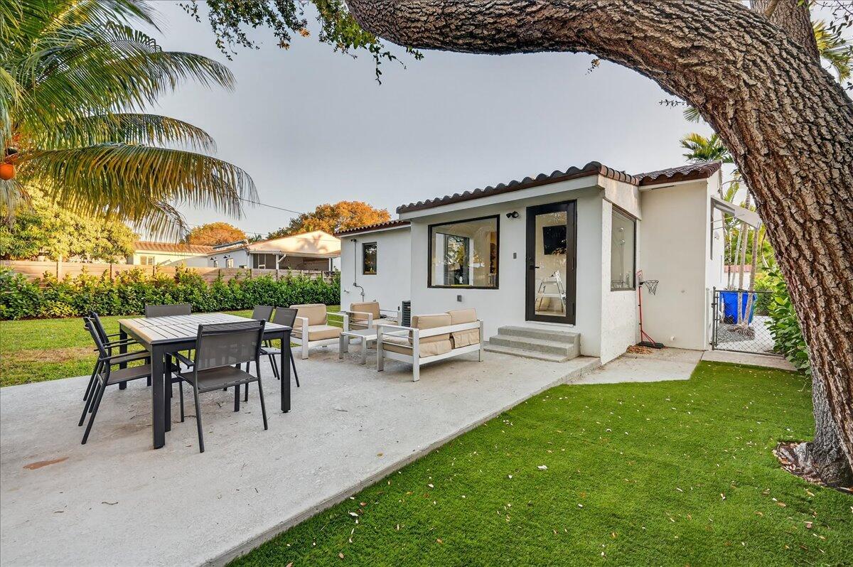 2601 Southwest 26th Lane Miami, FL 33133 - Photo 32 of 34 a view of a house with patio and a garden