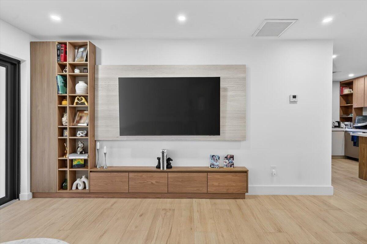2601 Southwest 26th Lane Miami, FL 33133 - Photo 5 of 34 a living room with flat screen tv and a book shelf