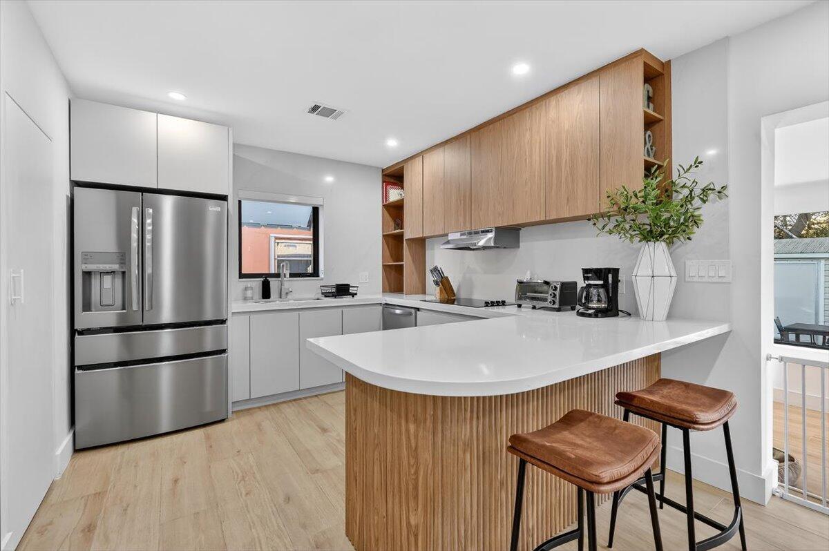 2601 Southwest 26th Lane Miami, FL 33133 - Photo 10 of 34 a kitchen with stainless steel appliances a refrigerator and a stove top oven