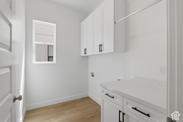 538 North Legend Circle, Unit 505 Mapleton, UT 84664 - Photo 31 of 48 Bright utility space featuring white cabinetry, light wood-finish flooring, a white countertop, and a window