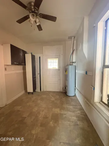 a view of a livingroom with a ceiling fan and window