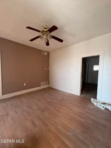a view of room with ceiling fan and window