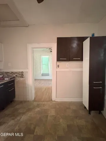 a view of kitchen with a sink and a refrigerator
