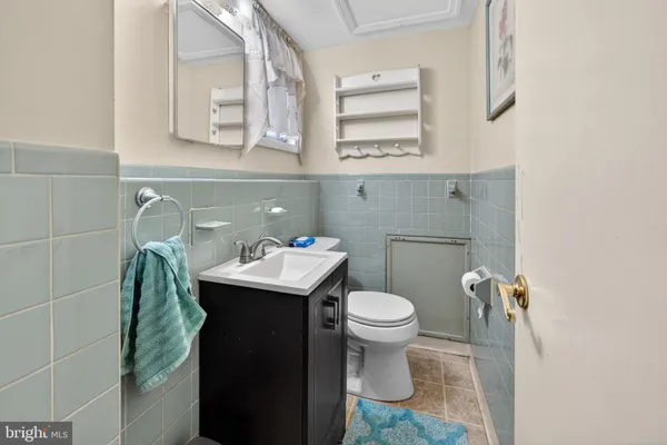 a bathroom with a sink toilet and mirror