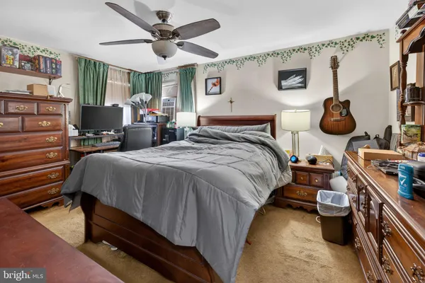 a bedroom with bed and a chandelier