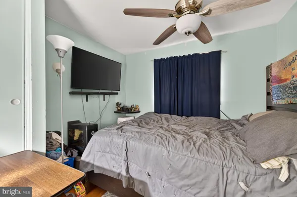 a bedroom with a bed and a flat screen tv