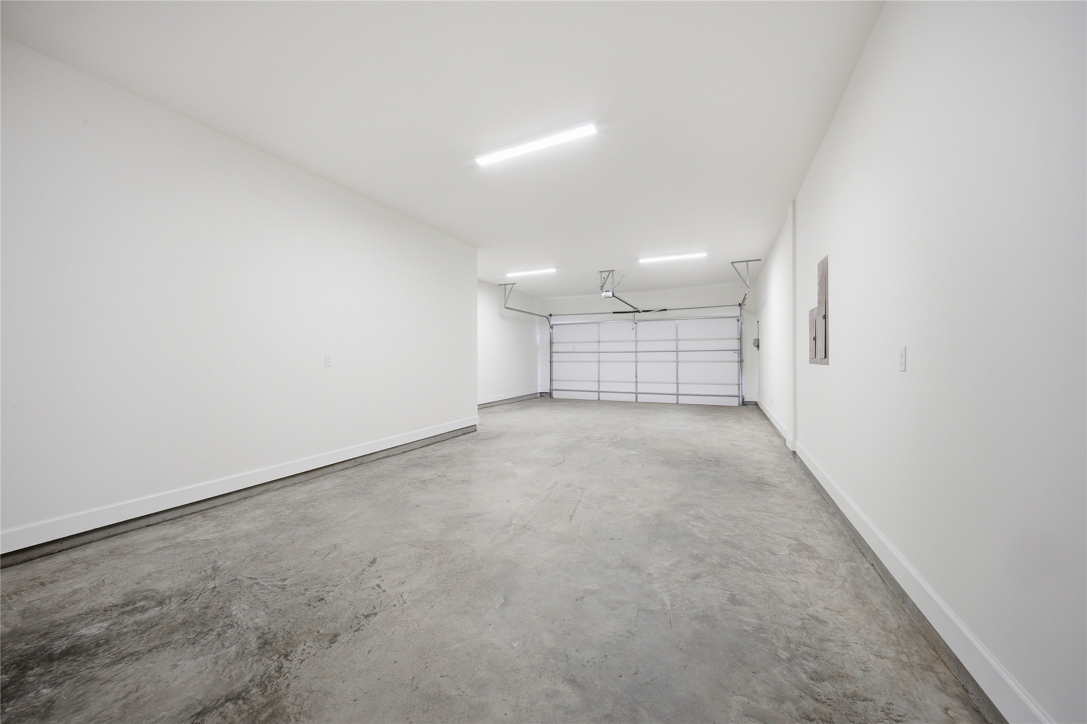 416 Venado View Court Conroe, TX 77304 - Photo 26 of 34 Expansive oversized 3-car garage offering ample space for vehicles, storage, workshop potential, and everyday convenience.